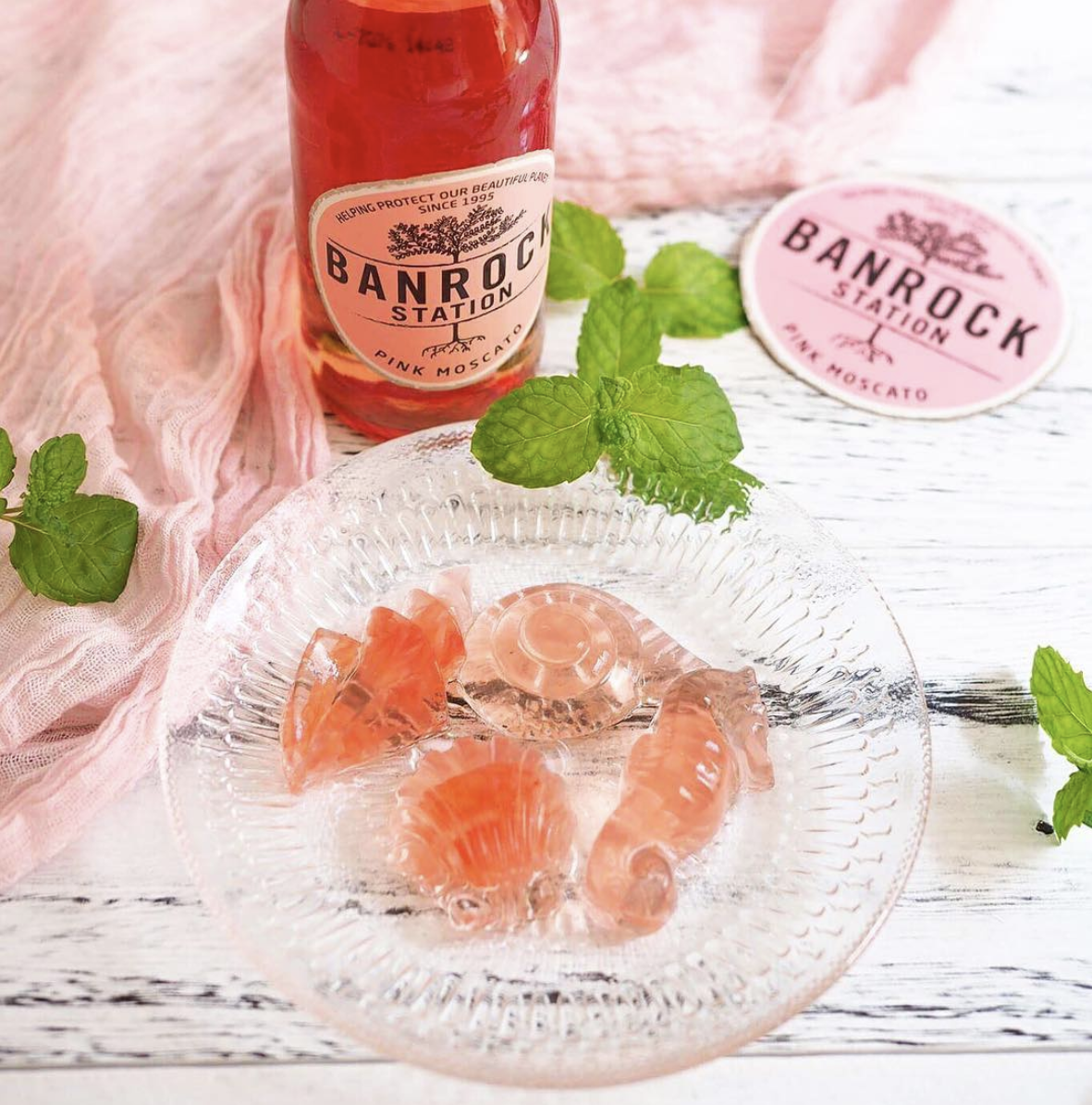 Pink moscato and grapefruit jellies on glass plate