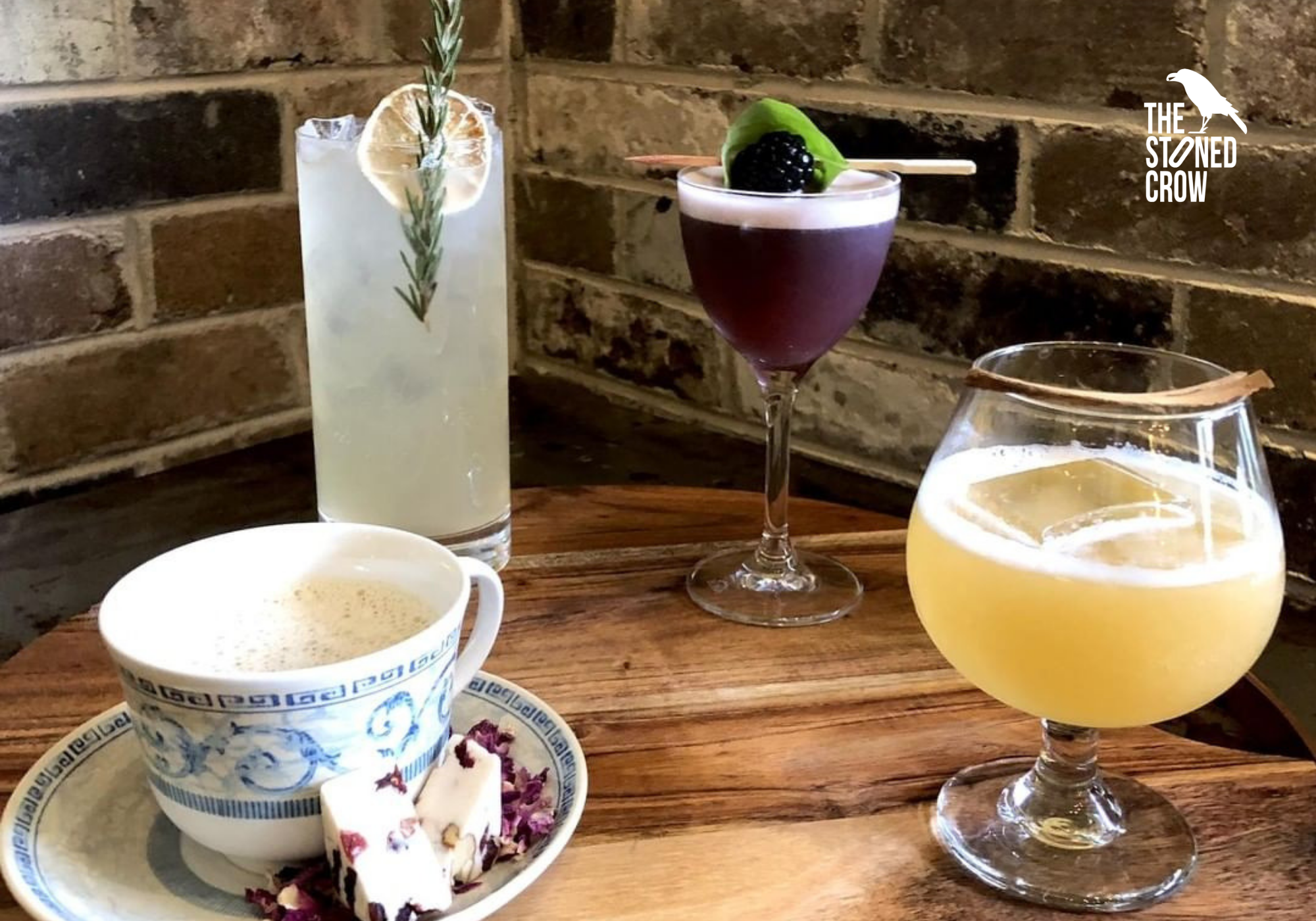 Four different winter-themed cocktails in different shaped glasses