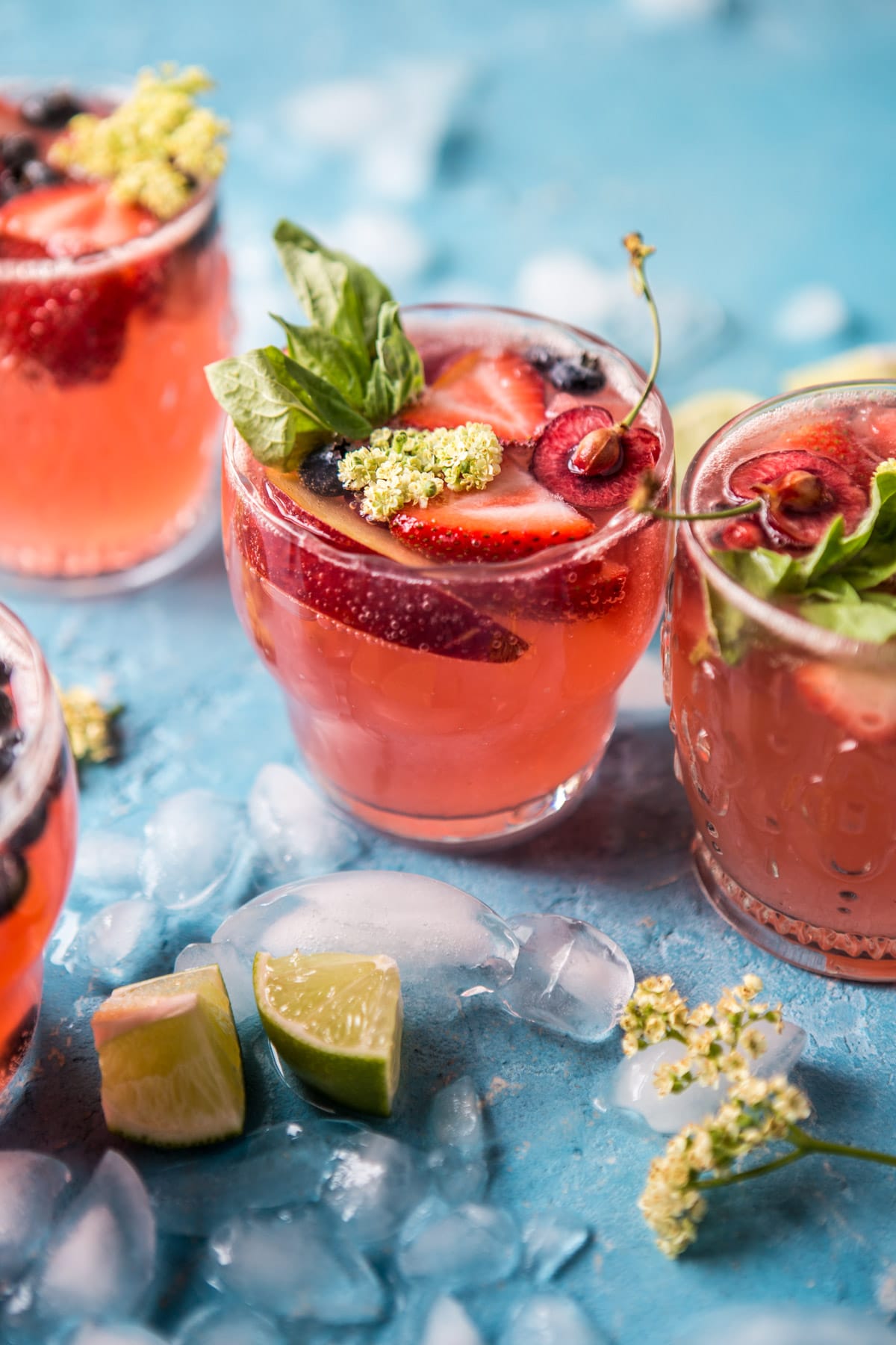 Summertime rose tequila sangria cocktail topped with strawberries and mint