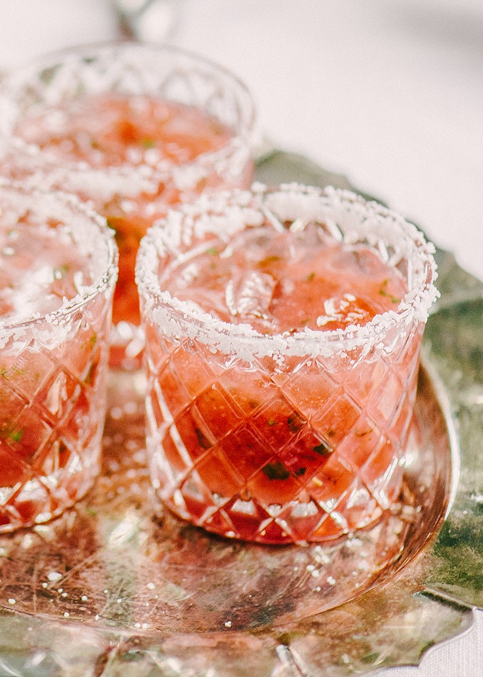 Strawberry basil margarita summer cocktails with salt rim on silver tray