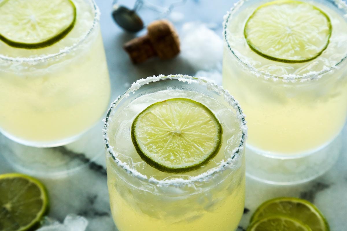 Prosecco margarita cocktail with lime wedge garnish in a salt rimmed glass