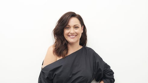 Portrait of Celeste Barber, she is posed in front of a white background and smiling.