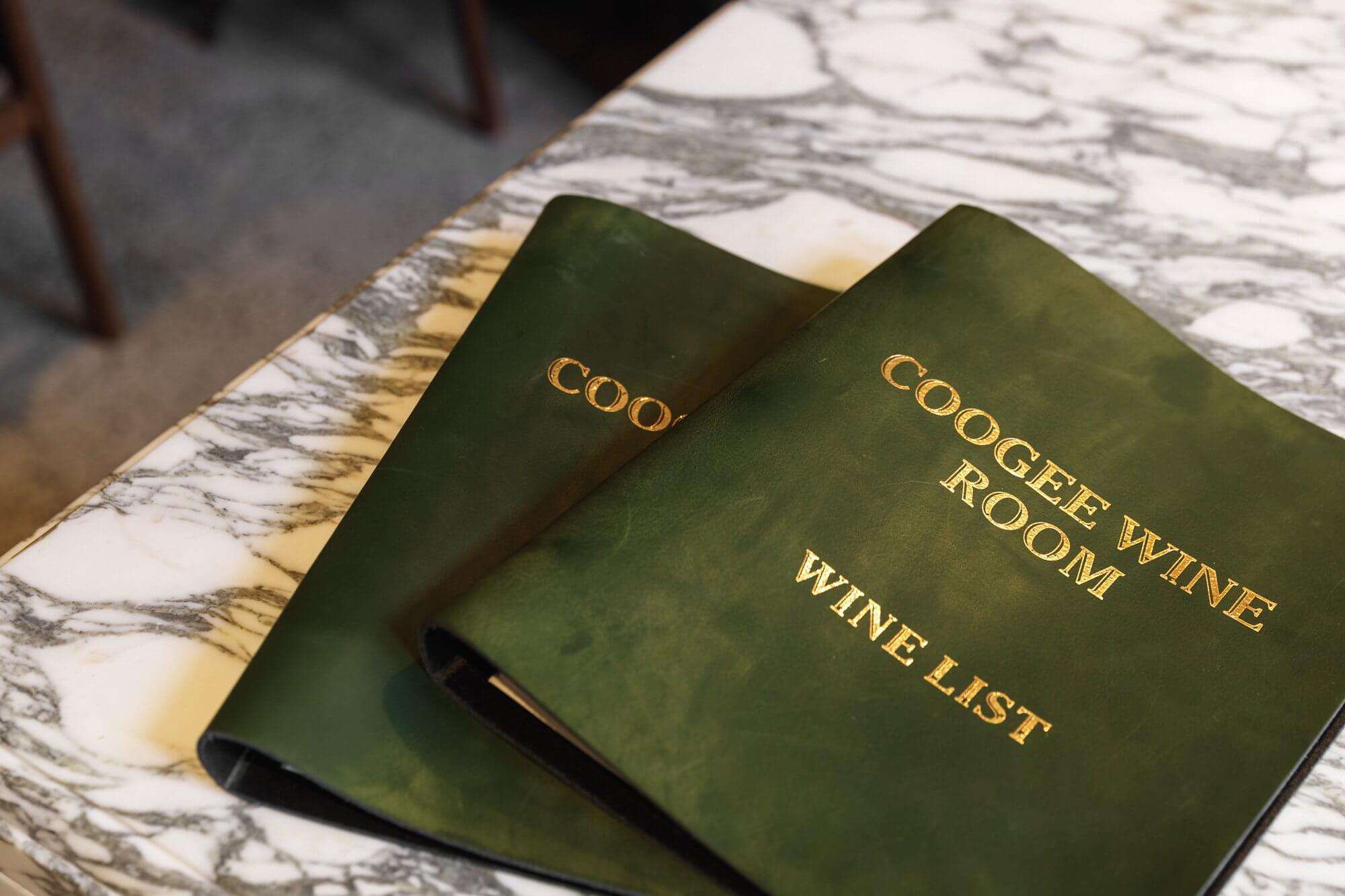 Distil coogee wine room logo branding menu covers green leather